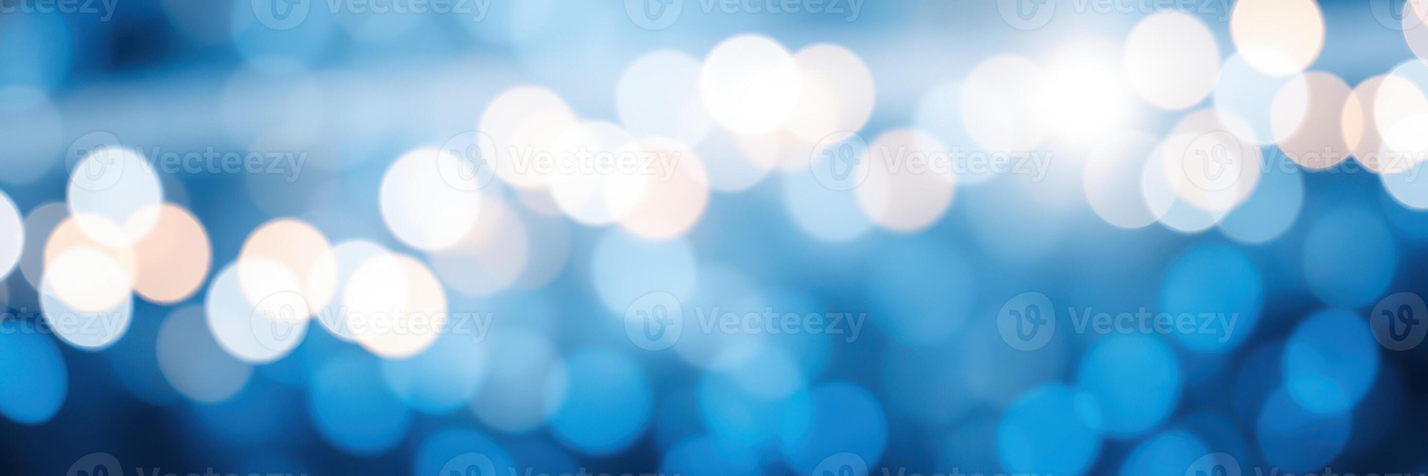 Beautiful blue bokeh lights twinkling softly in a nighttime urban setting during a festive gathering photo