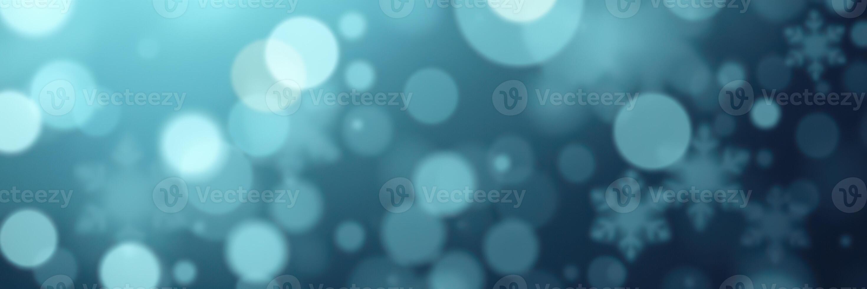 Soft blue bokeh background with delicate snowflakes creating a serene winter atmosphere photo