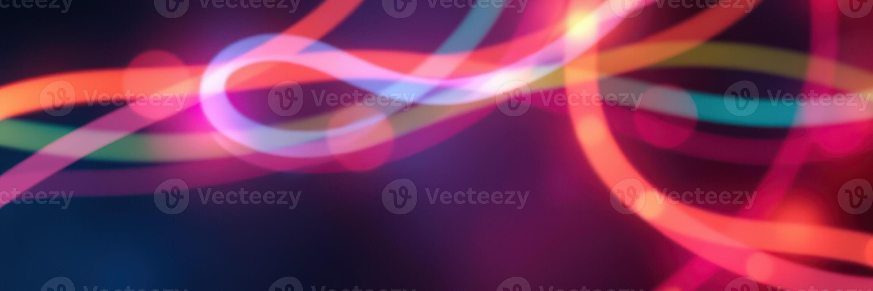 Colorful light trails create an abstract background with vibrant patterns of energy and motion in a dark space photo