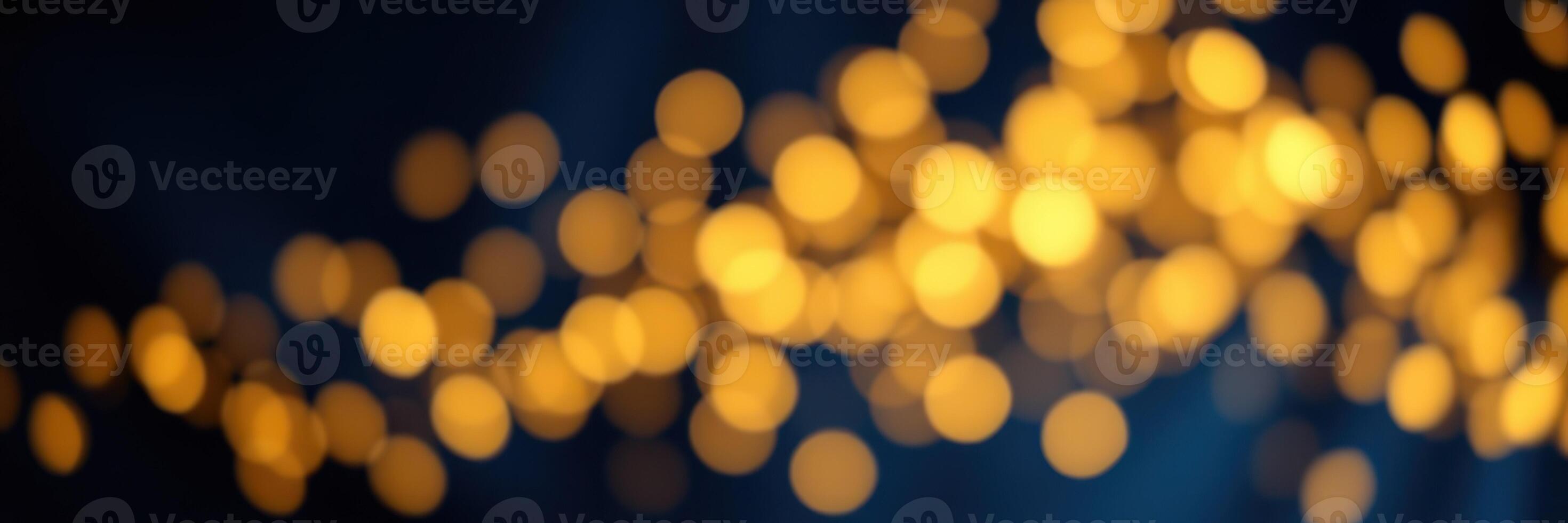 Soft golden bokeh lights create a dreamy atmosphere in a dimly lit setting during evening hours photo