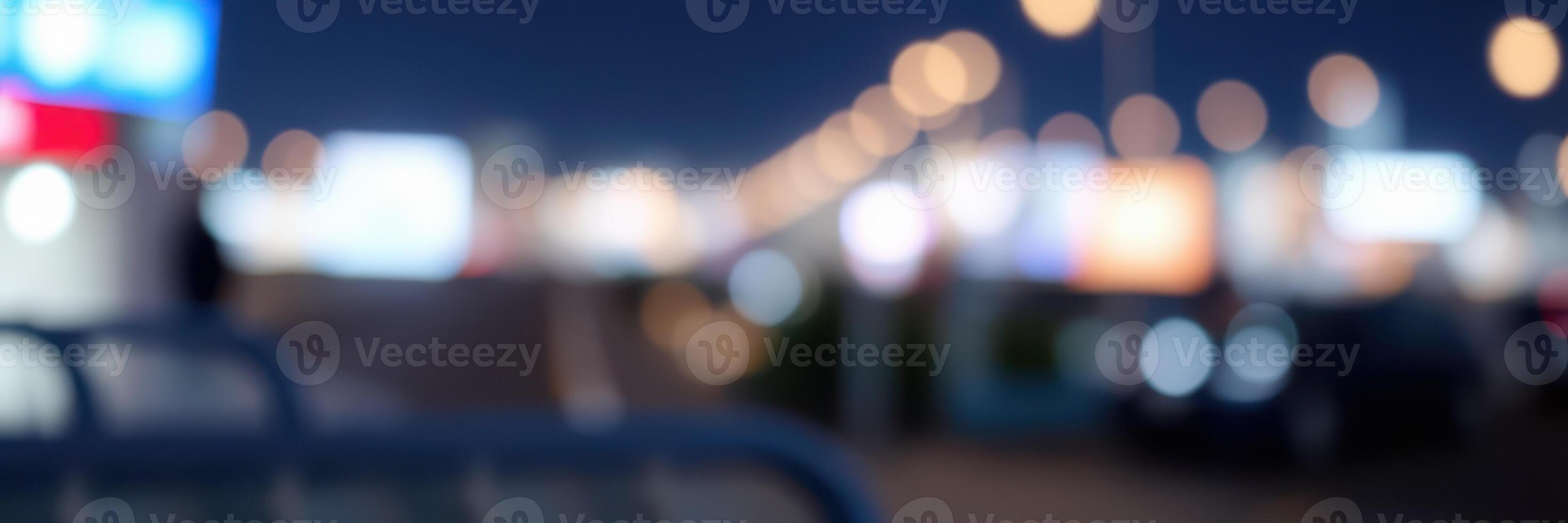 Vibrant city lights illuminate a bustling urban street during nighttime hours photo
