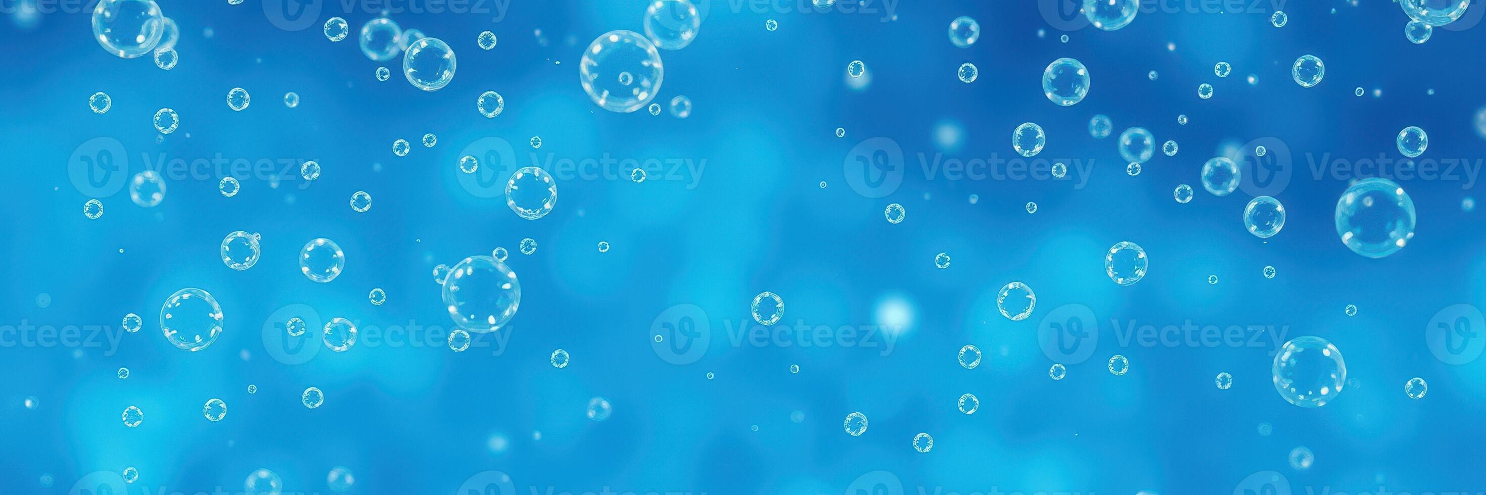 Bubbles rise gracefully in clear blue water, creating a serene underwater atmosphere during daylight hours photo