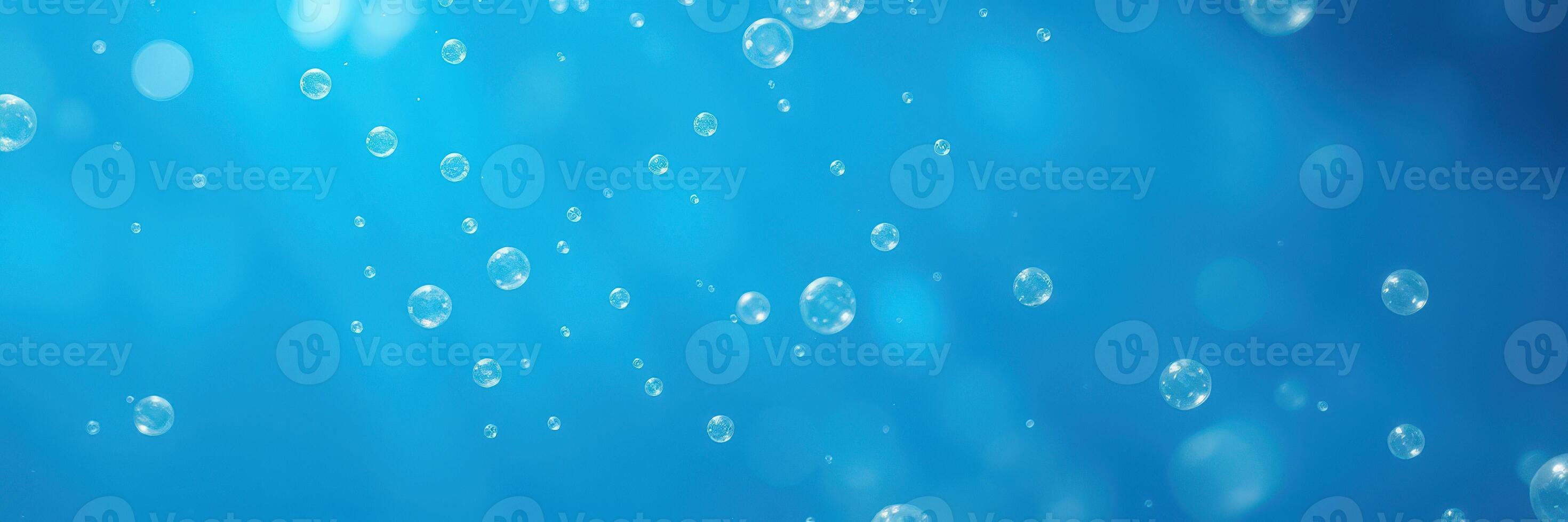 Bubbles rising in clear blue water creating a calming underwater atmosphere full of movement and light photo