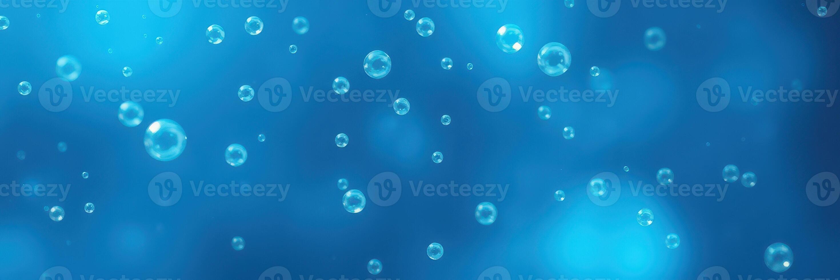 Bubbles rising through sparkling blue water in a serene underwater environment photo