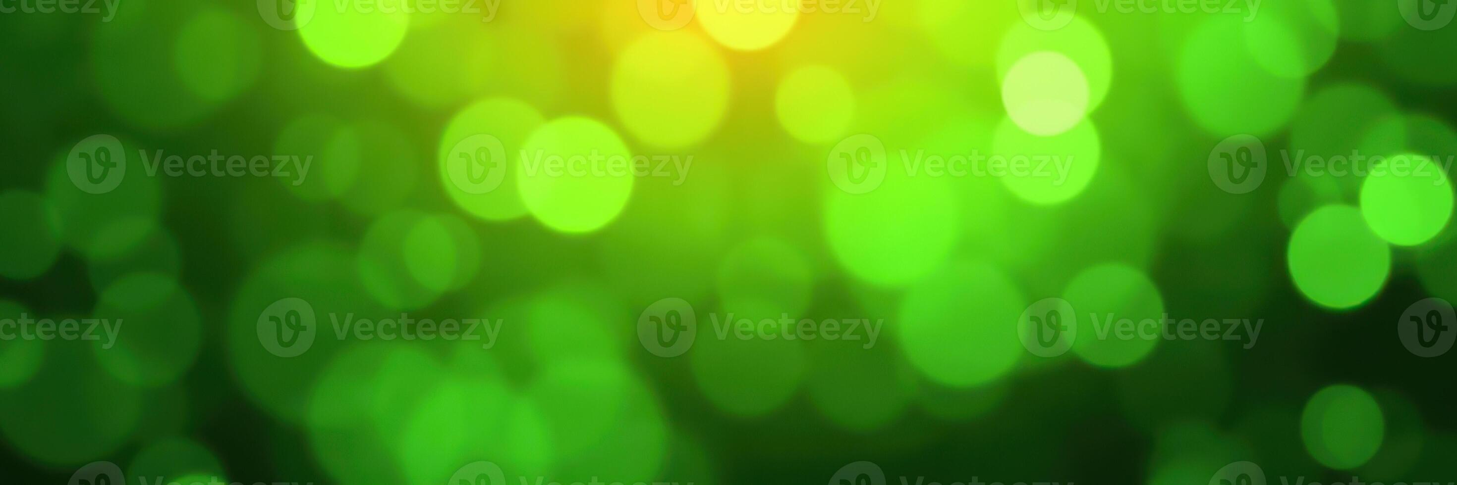 Beautiful green bokeh background reflecting light during a sunny day in nature photo