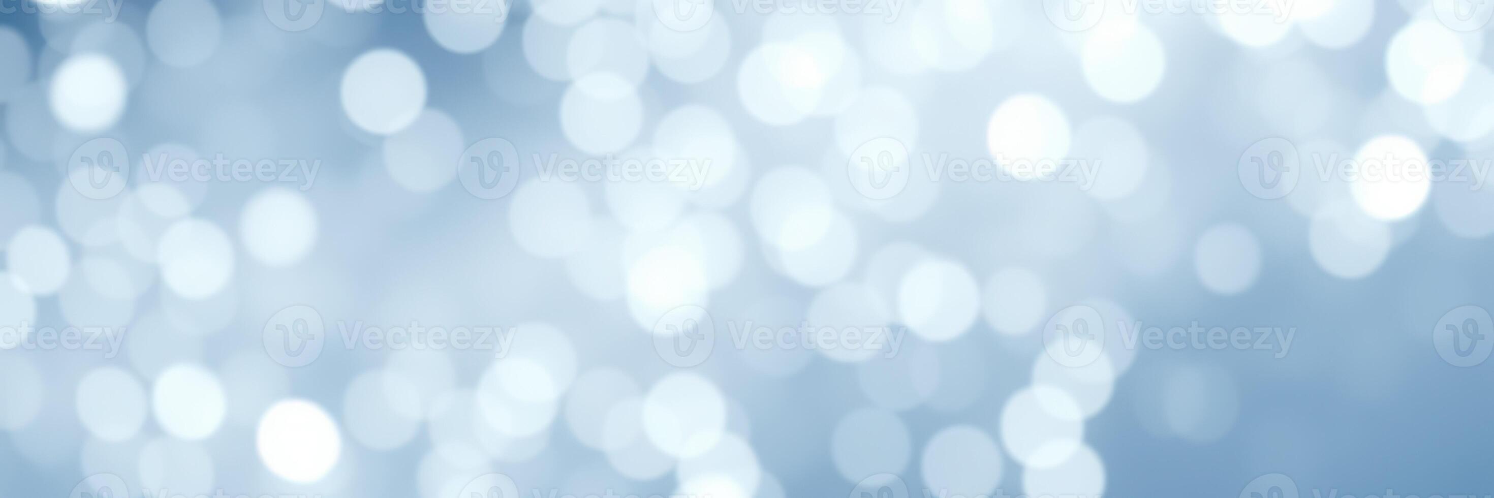 Soft bokeh lights create a dreamy atmosphere in a serene blue background during daylight hours photo