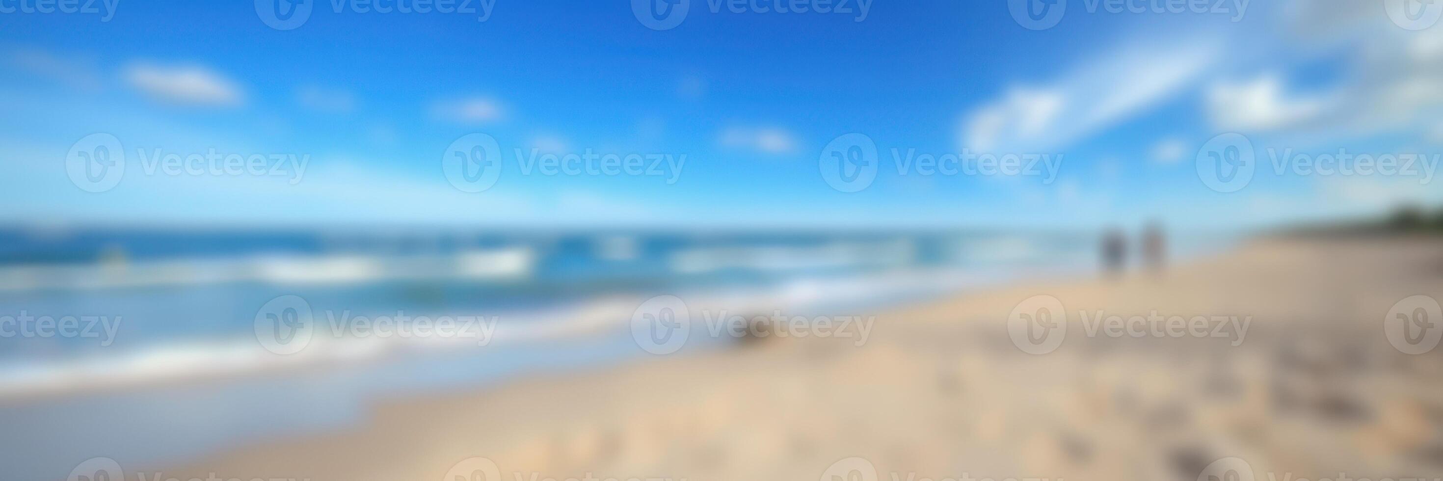 Relaxing beach day with gentle waves and clear blue sky during a sunny afternoon photo