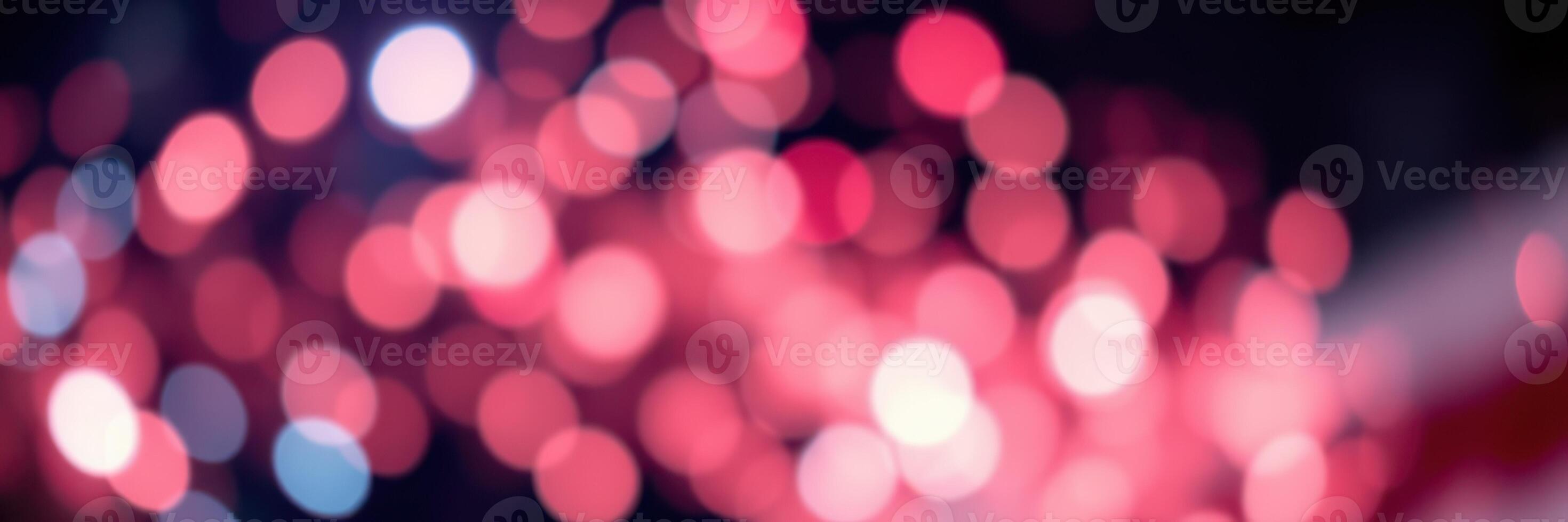 Colorful bokeh lights create a festive atmosphere at night in a vibrant urban setting photo