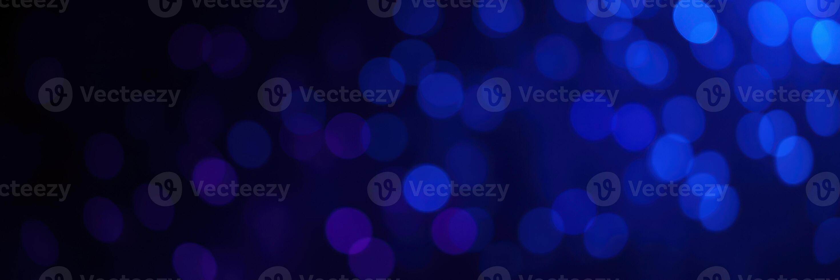 Vibrant blue bokeh lights creating a mesmerizing visual effect in a dark backdrop photo