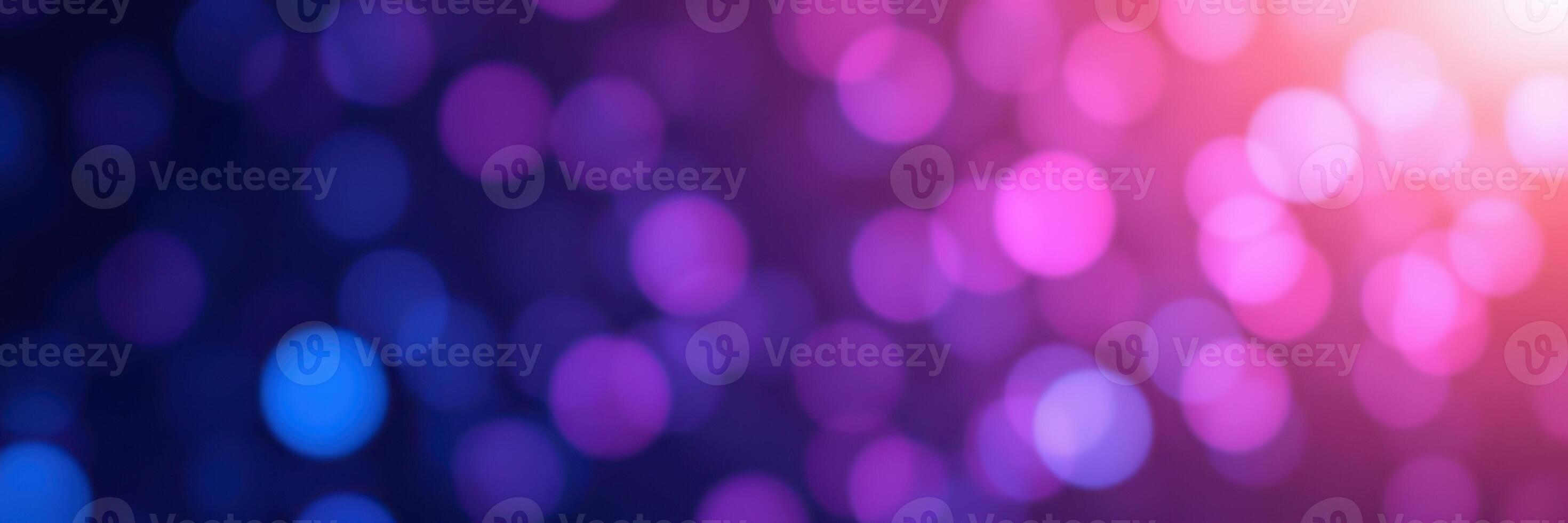 Colorful bokeh lights create a dreamy background at a nighttime event with vibrant hues of purple, blue, and pink photo