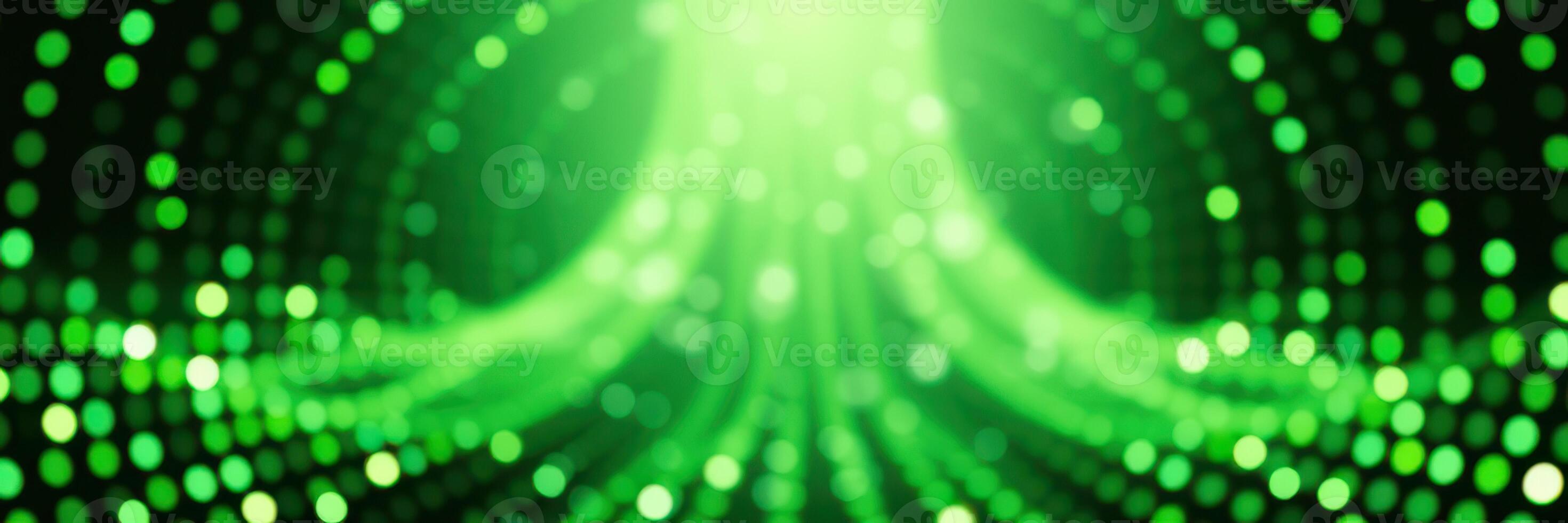 Vibrant green abstract background with glowing dots creating a dynamic wave effect during a digital display event photo