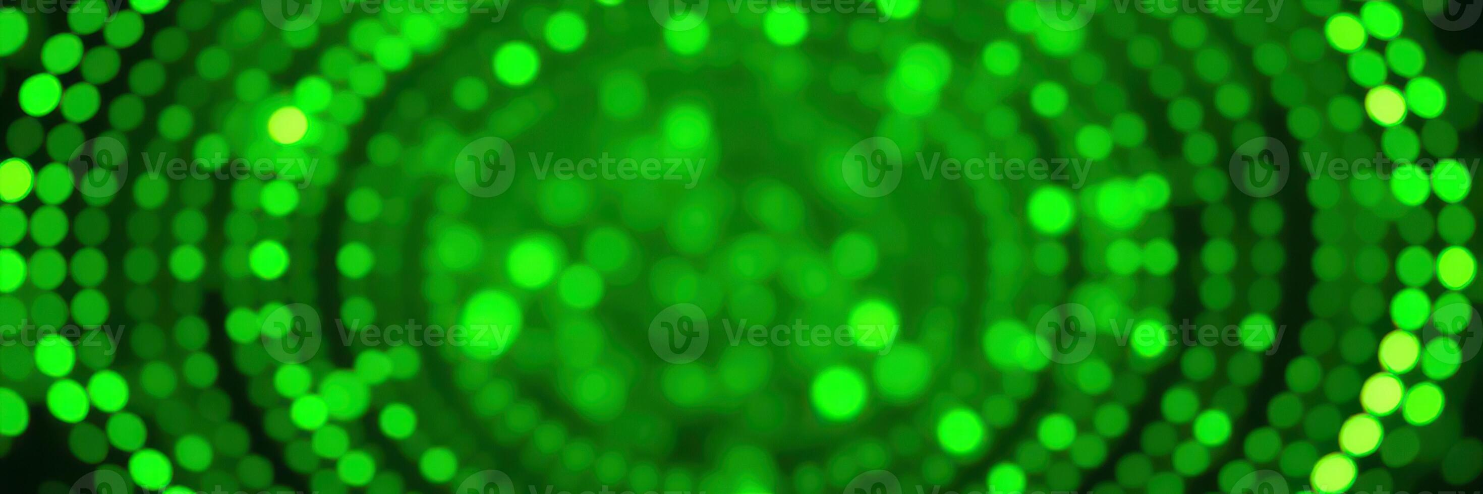 Bright green illuminated abstract background with a soft bokeh effect creating a festive atmosphere for celebrations and events photo