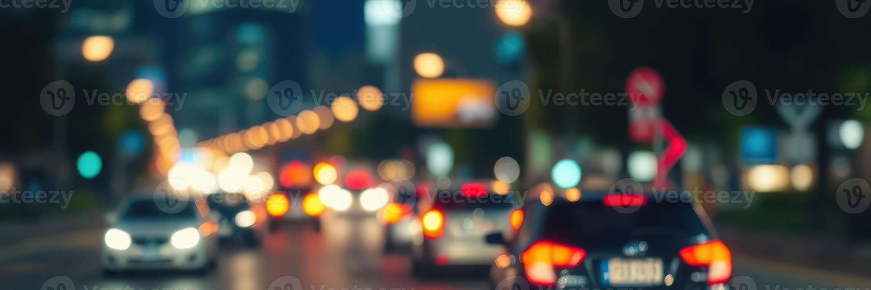 City streets illuminated by nighttime traffic with blurred vehicle lights and structures in the background photo