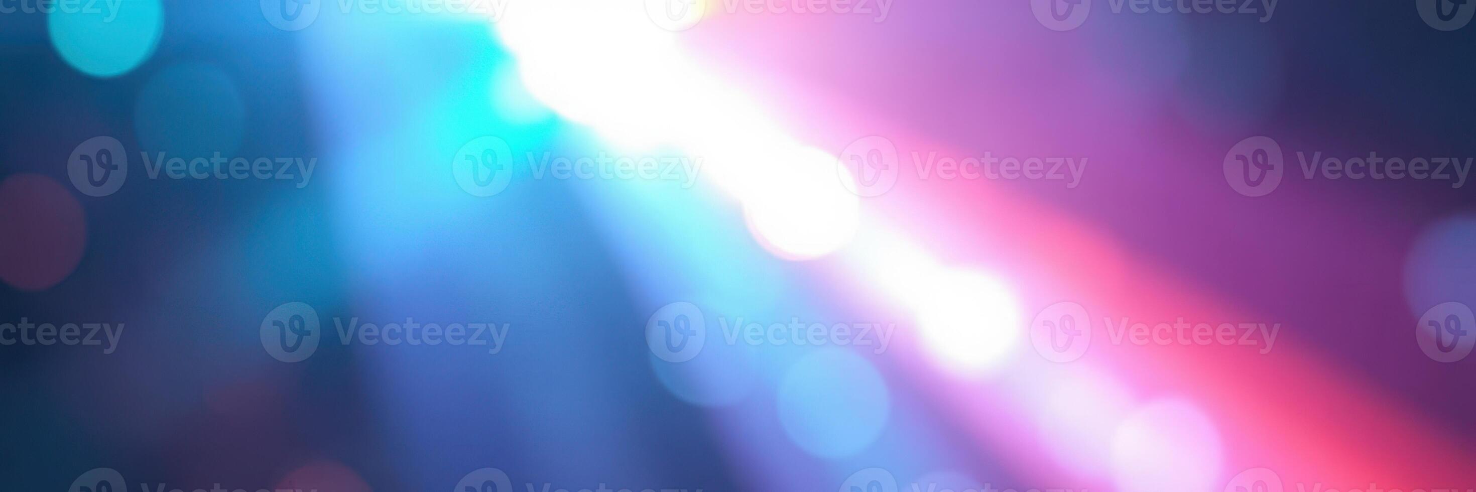 Colorful light beams create a vibrant atmosphere at a nighttime celebration in an urban setting photo