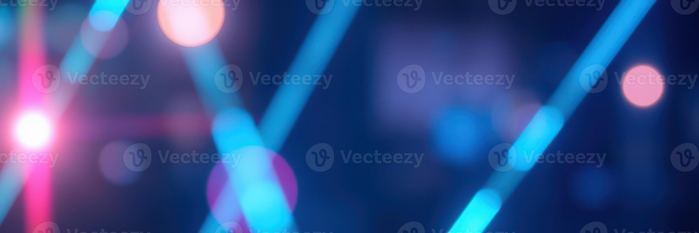 Colorful neon lights create a vibrant atmosphere in an urban nightlife setting during a lively evening event photo