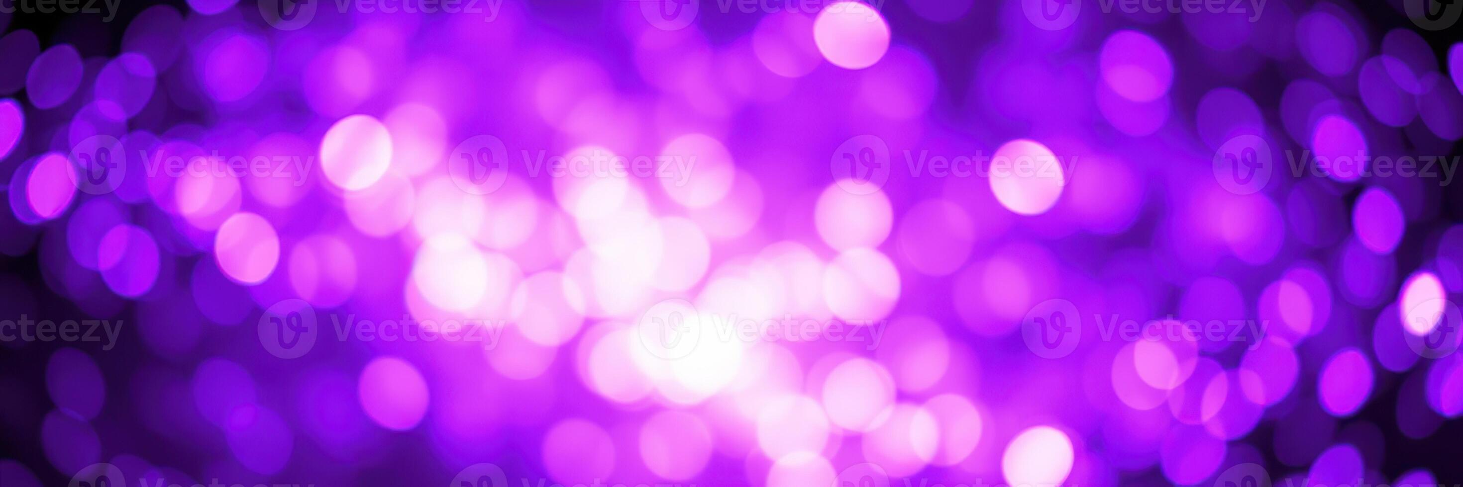 Colorful purple bokeh lights create an abstract background perfect for celebrations and artistic projects photo