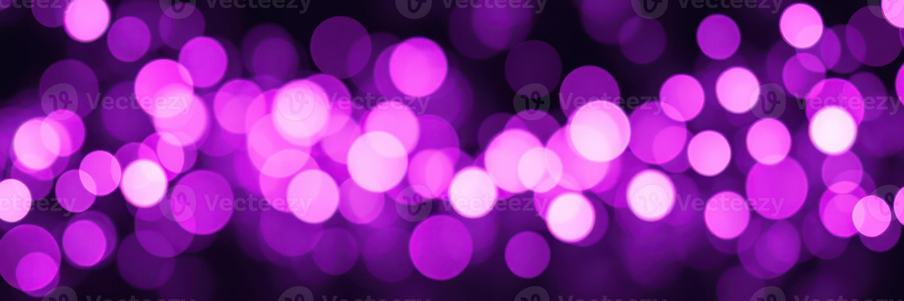 Vibrant purple bokeh lights create a dreamy atmosphere for an evening event photo