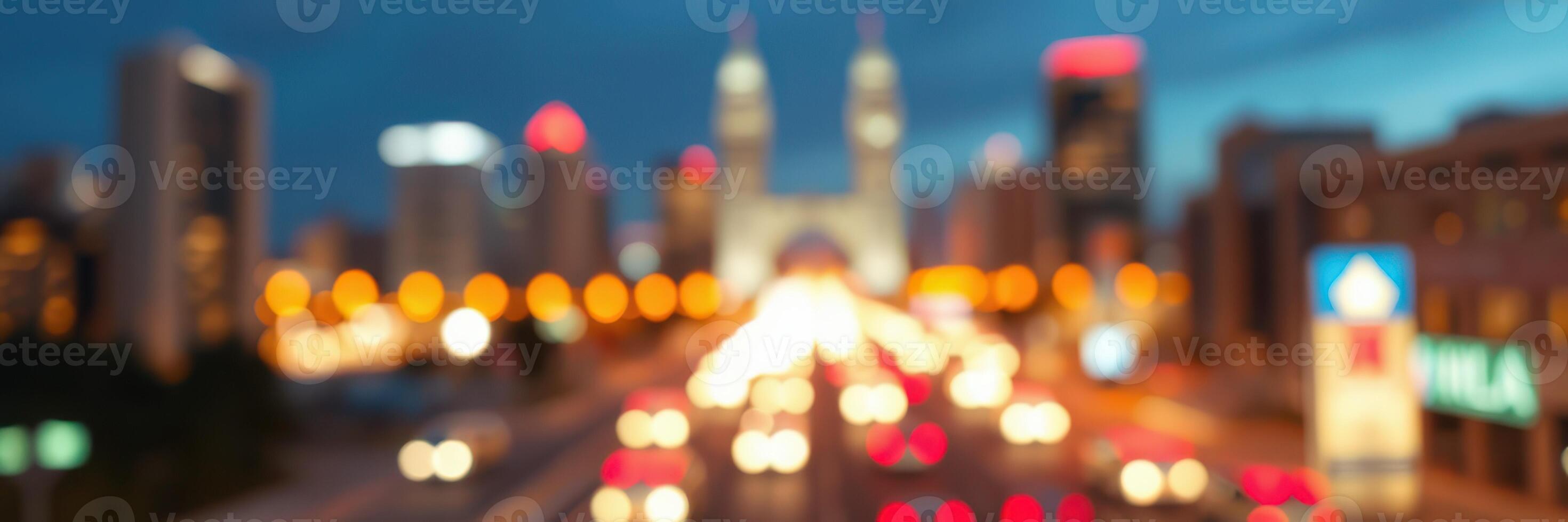 City skyline at dusk with vibrant lights and traffic flowing under a monumental arch photo