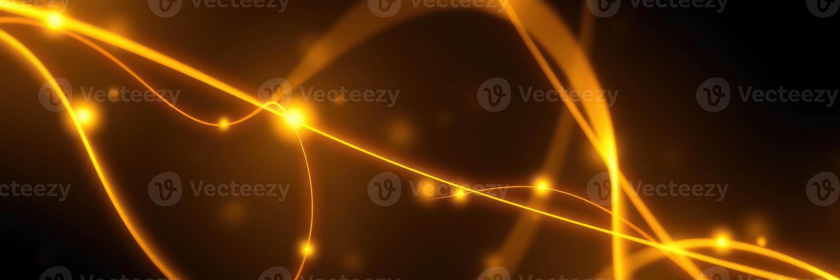 Bright and fluid golden light strands weaving through a dark background in an abstract display of movement and energy photo