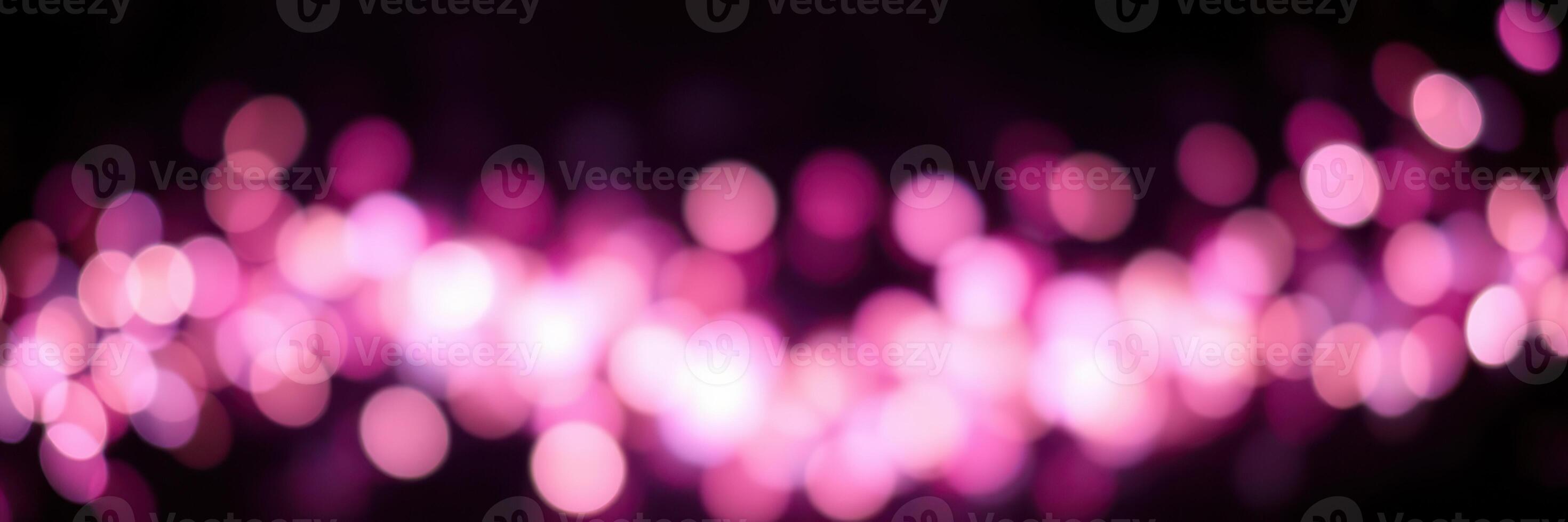 Vibrant pink bokeh lights creating a dreamy atmosphere during a nighttime event photo