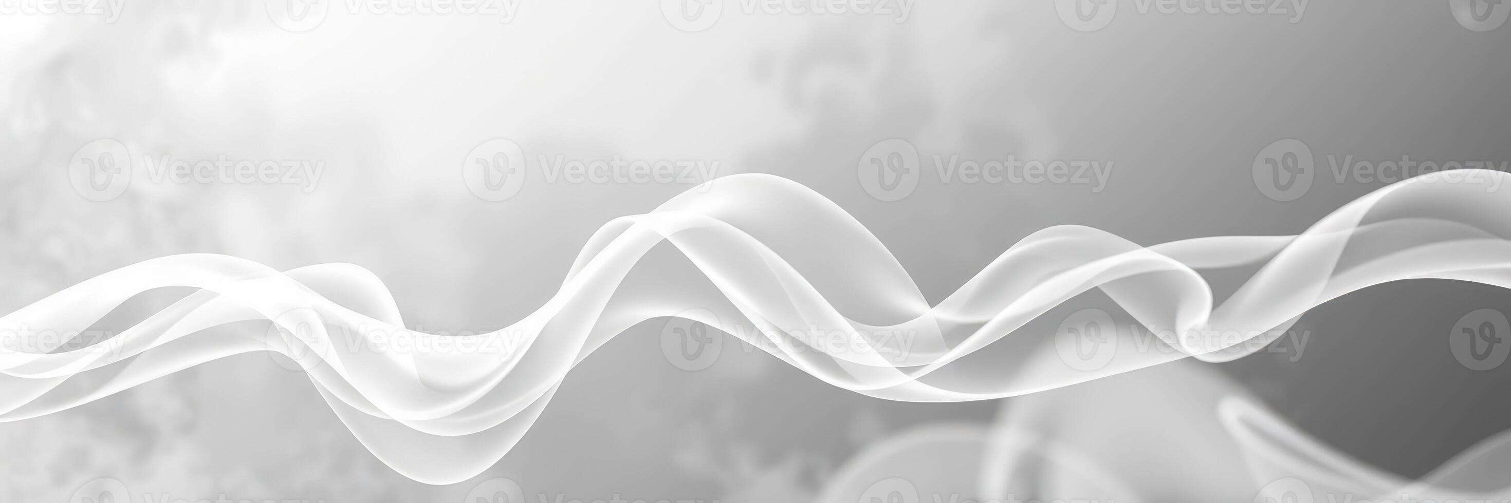 Ethereal white smoke gently swirls against a blurred gray background creating a dreamy atmosphere photo