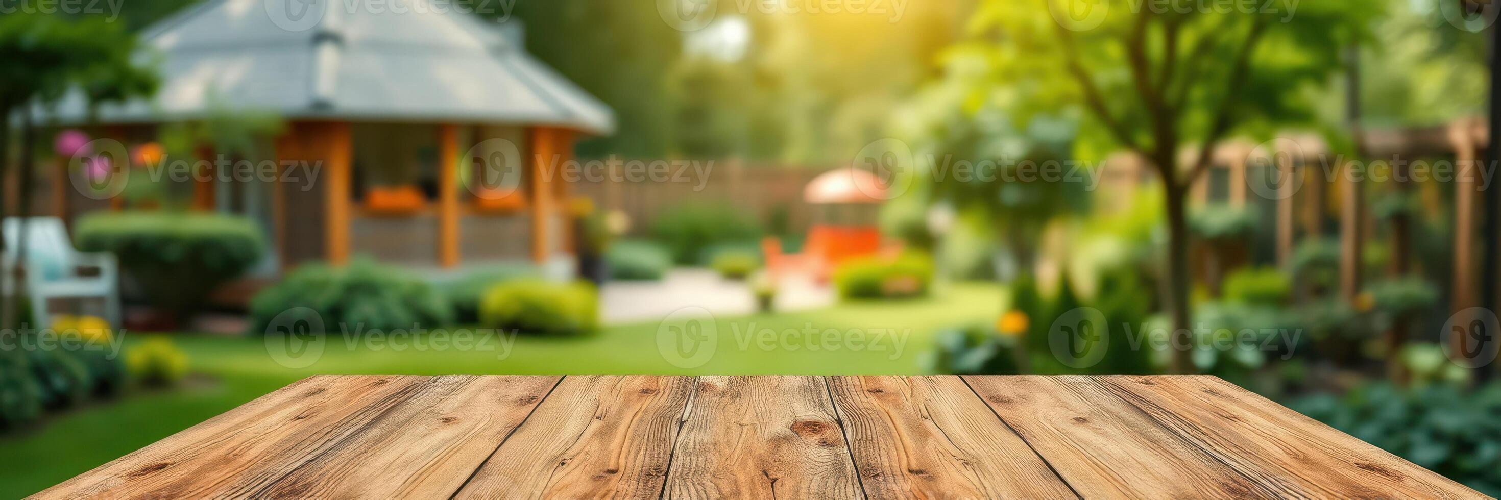 Beautiful garden setting with wooden table and vibrant greenery in warm evening light photo