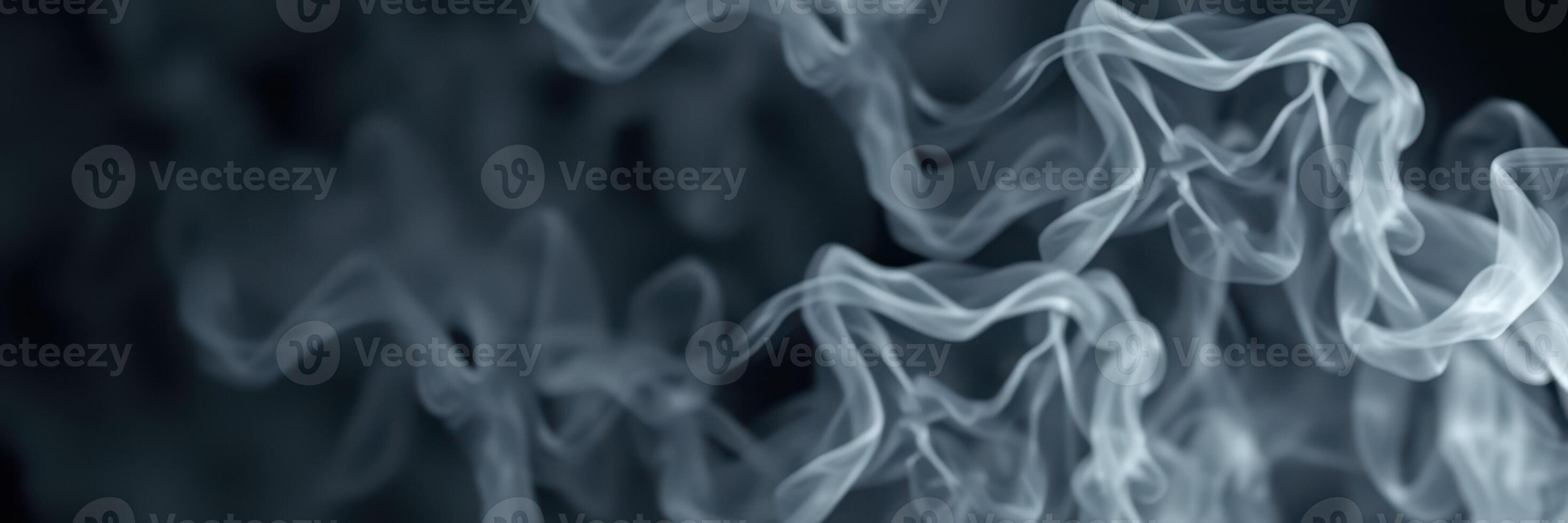 Wispy strands of smoke swirl gracefully in a dimly lit space showcasing fluid movement and texture photo