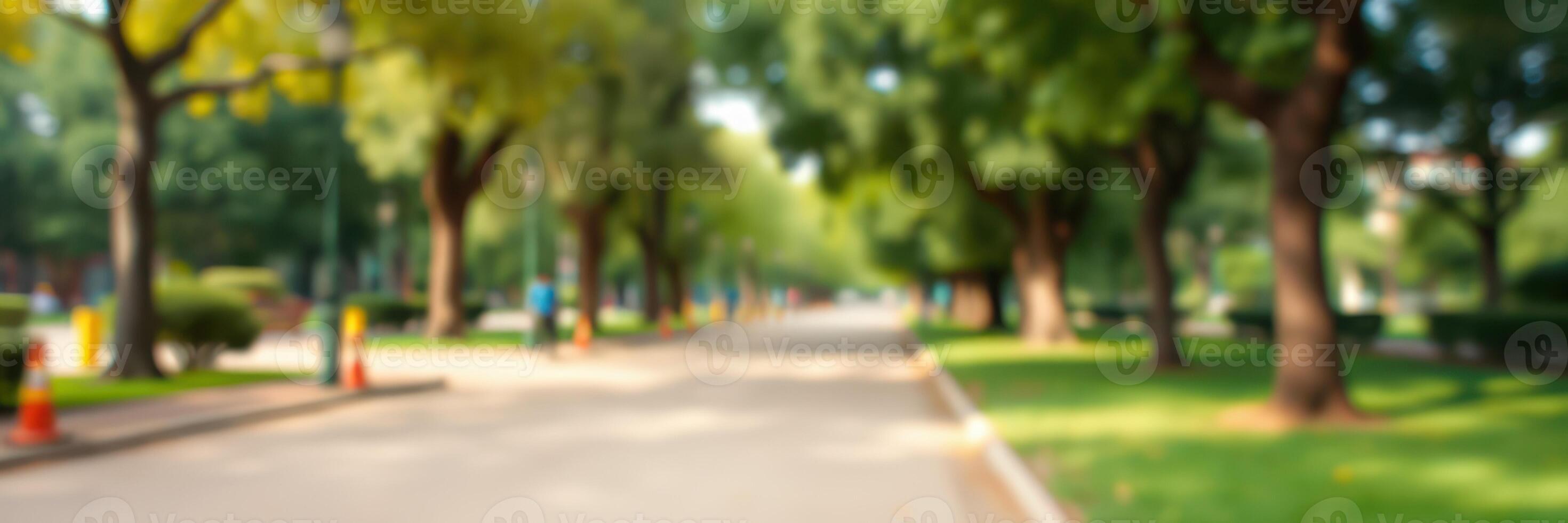 Lush green park path with cyclists enjoying a sunny afternoon in a suburban area photo