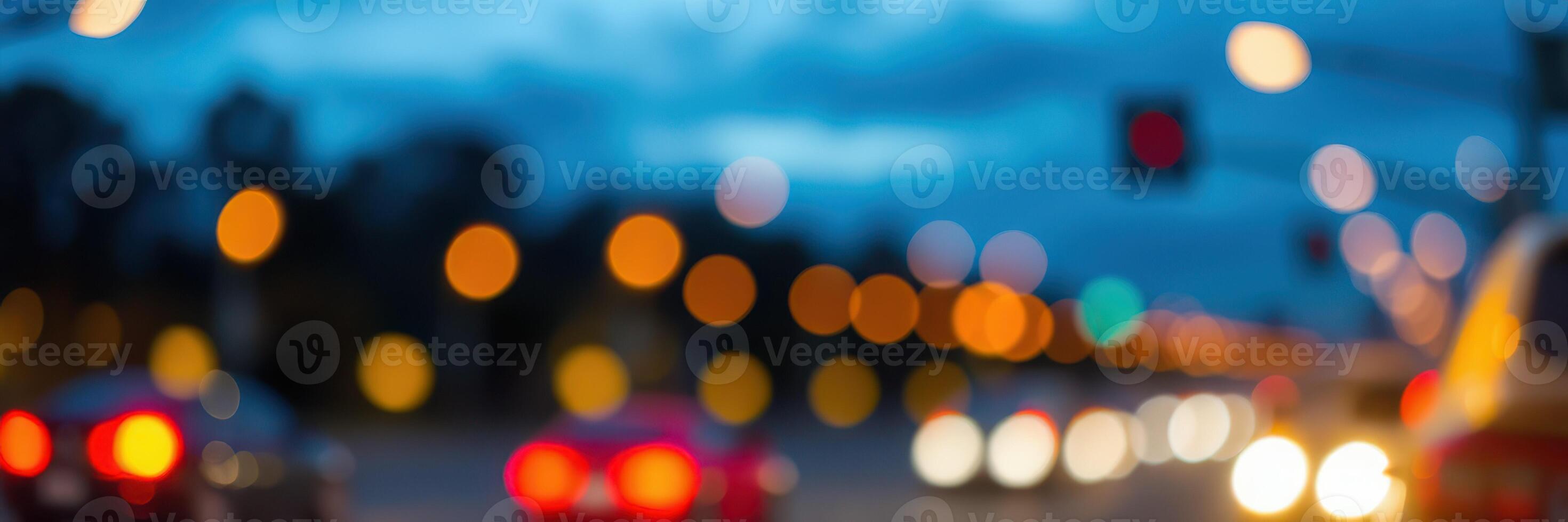 Traffic flows under dim evening lights in an urban setting with blurred vehicles creating a dynamic atmosphere photo