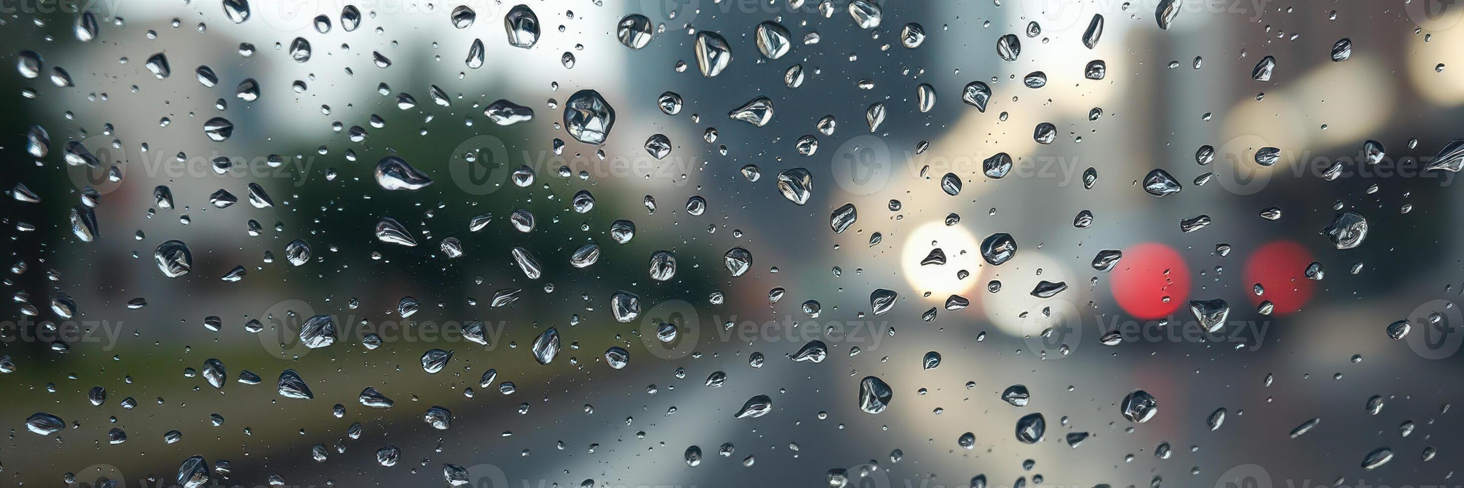 Rainy day drive through a busy city street with blurred lights and water droplets on the windshield photo