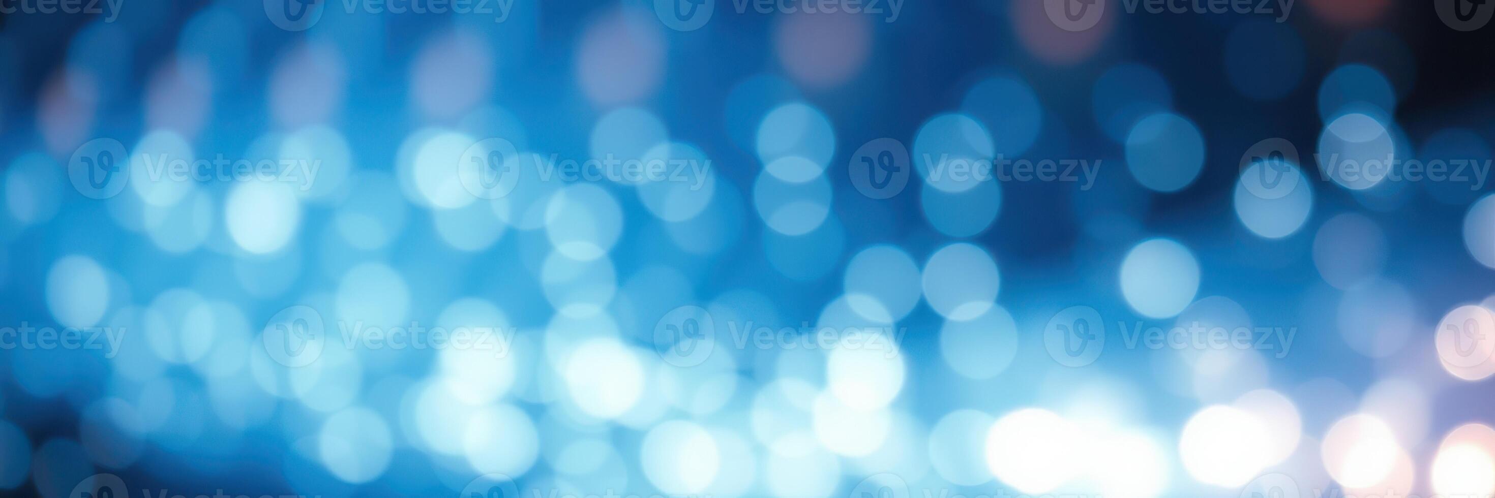 Vibrant blue abstract background with shimmering lights and bokeh effect creating a dreamy atmosphere photo