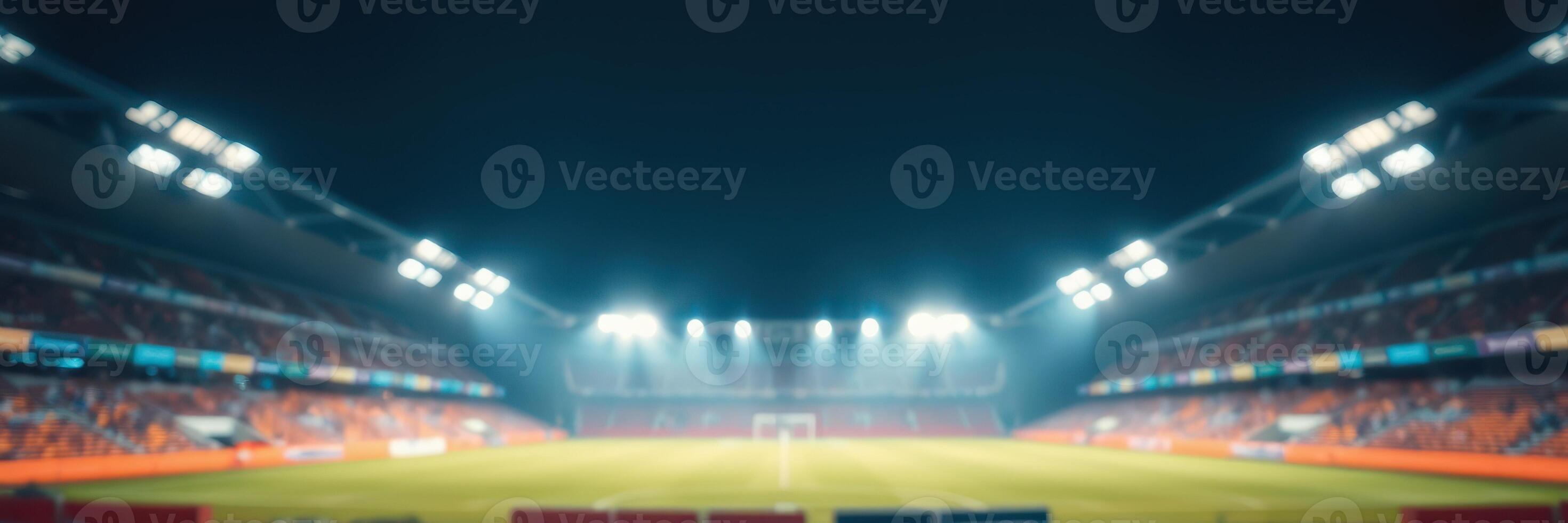 Football stadium illuminated at night during a match with fans and players present photo