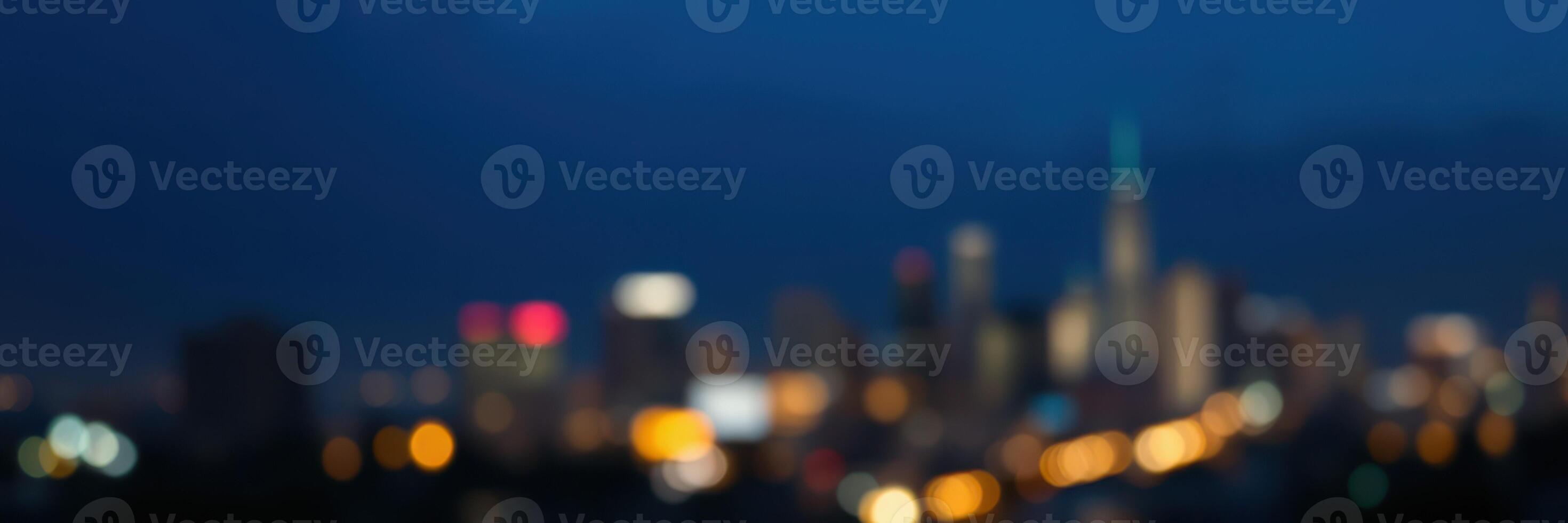 Vibrant city skyline illuminated at dusk with blurred lights creating a lively atmosphere photo