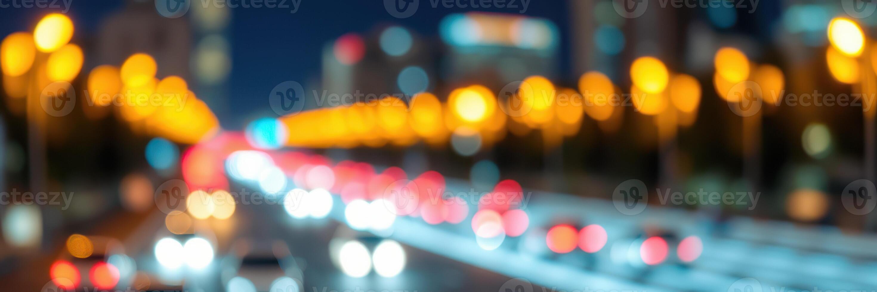 City street illuminated at night with blurred lights and moving cars creating a dynamic urban atmosphere photo