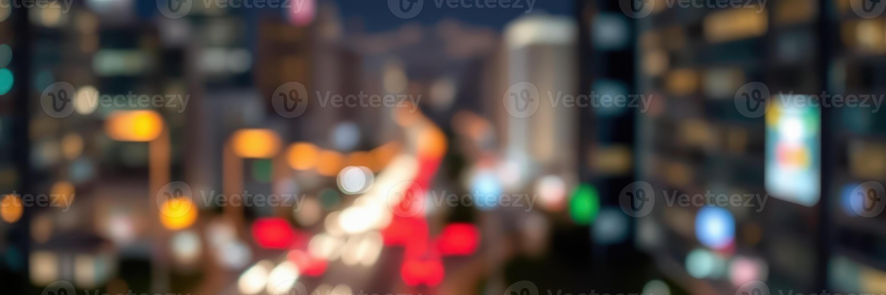 City skyline with blurred lights and busy urban traffic during nighttime hours photo