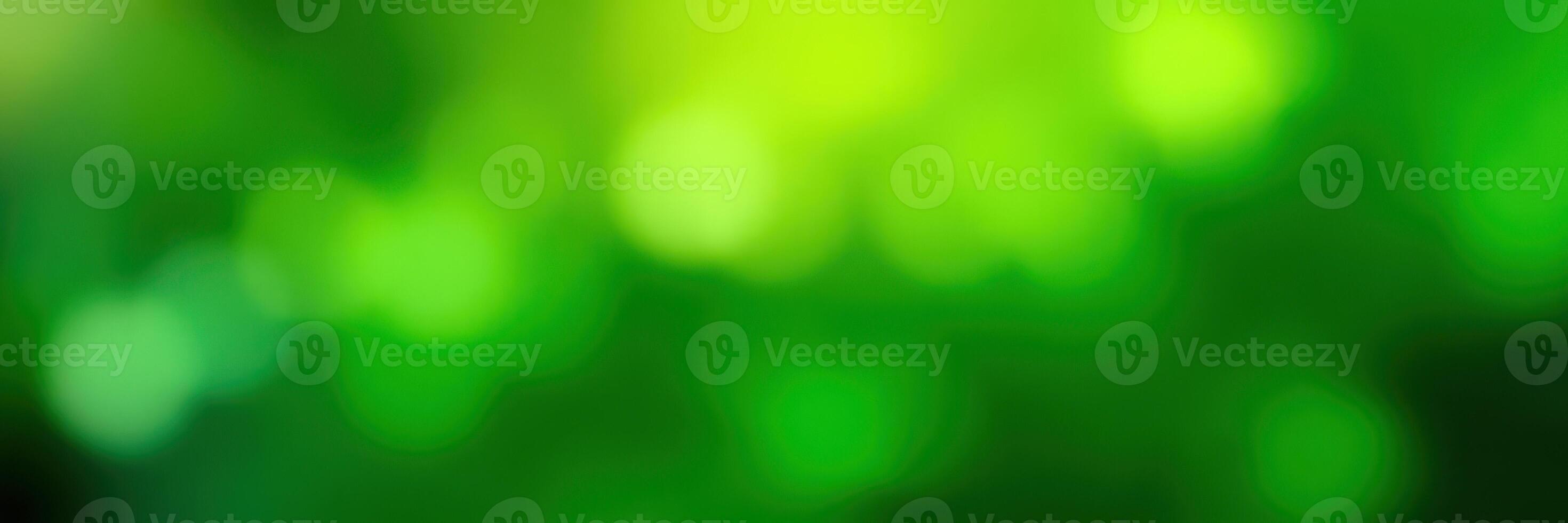 Vibrant green blurred backdrop creates a soothing atmosphere for artistic or nature-themed projects photo