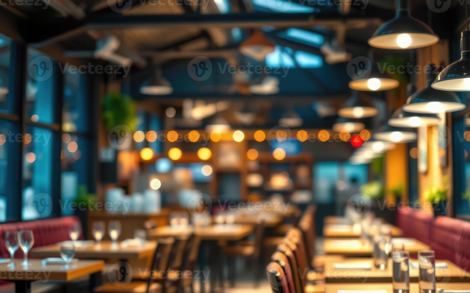 Cozy dining area with warm lighting and elegant table settings in a modern restaurant during evening hours photo