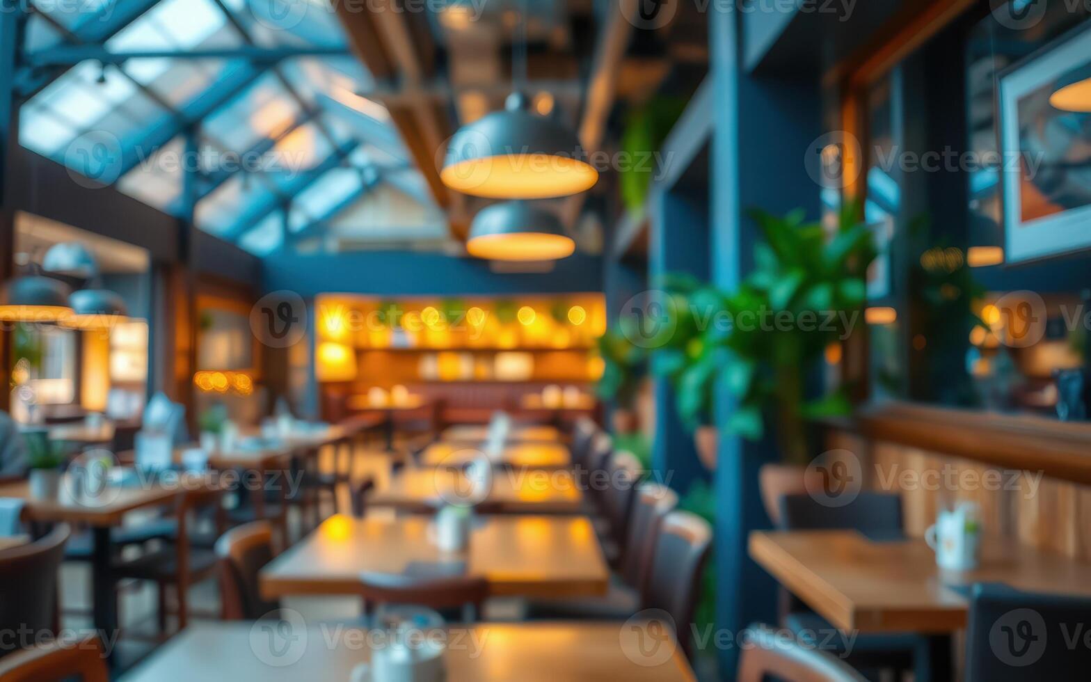 Cozy dining area with warm lighting and greenery in a bright restaurant setting photo