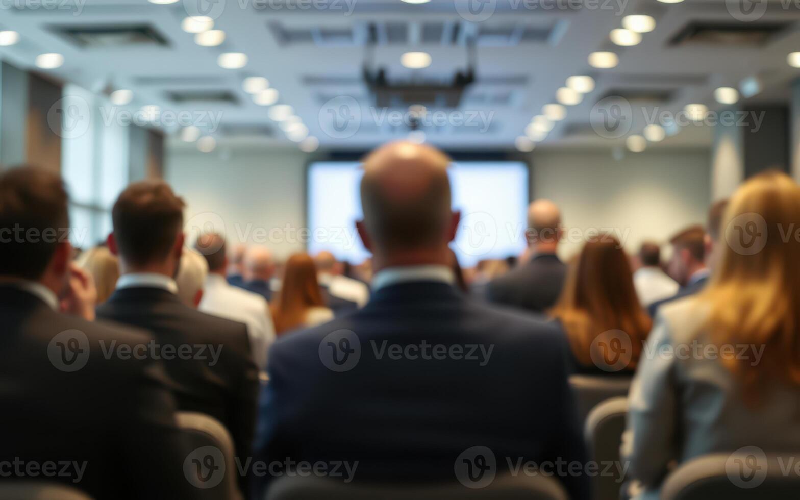 Conference attendees engaged in networking and discussions at a corporate event in a modern venue photo