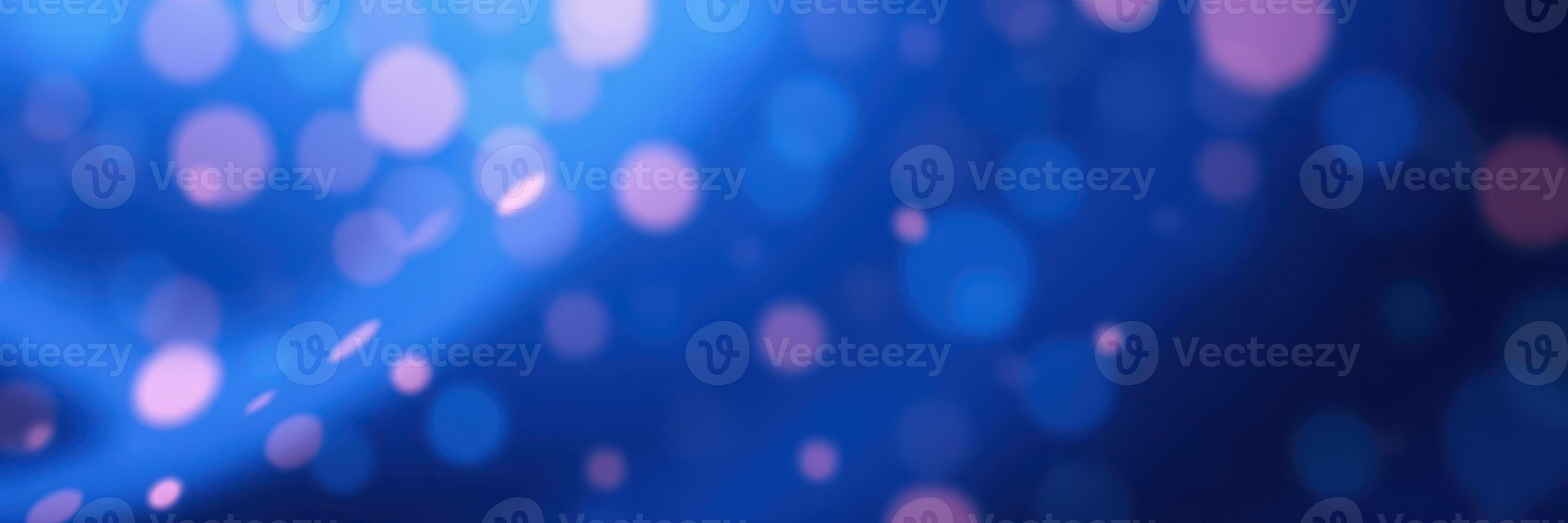 Colorful bokeh lights create an enchanting atmosphere in a vibrant blue background during a festive event photo