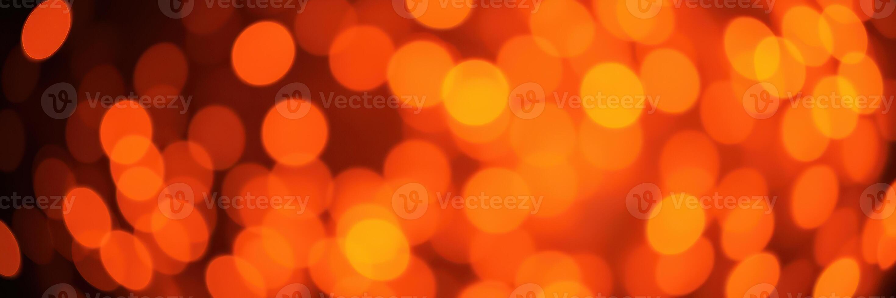 Bright orange bokeh lights create a warm and inviting atmosphere during an evening celebration photo