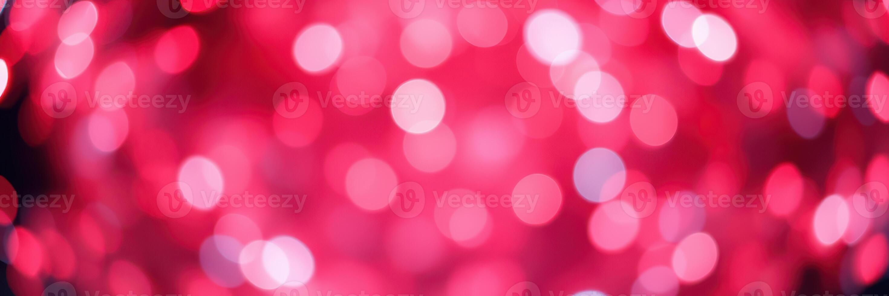 Vibrant display of red and pink bokeh lights creates a festive atmosphere during evening event photo