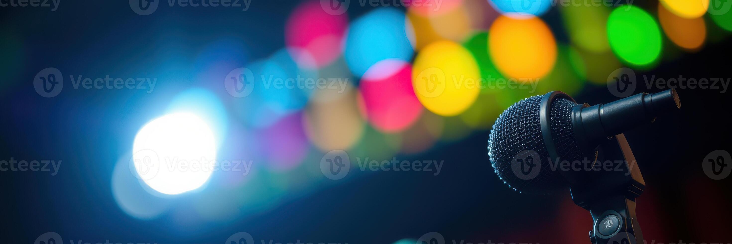 Microphone ready for performance under colorful lights at evening event photo