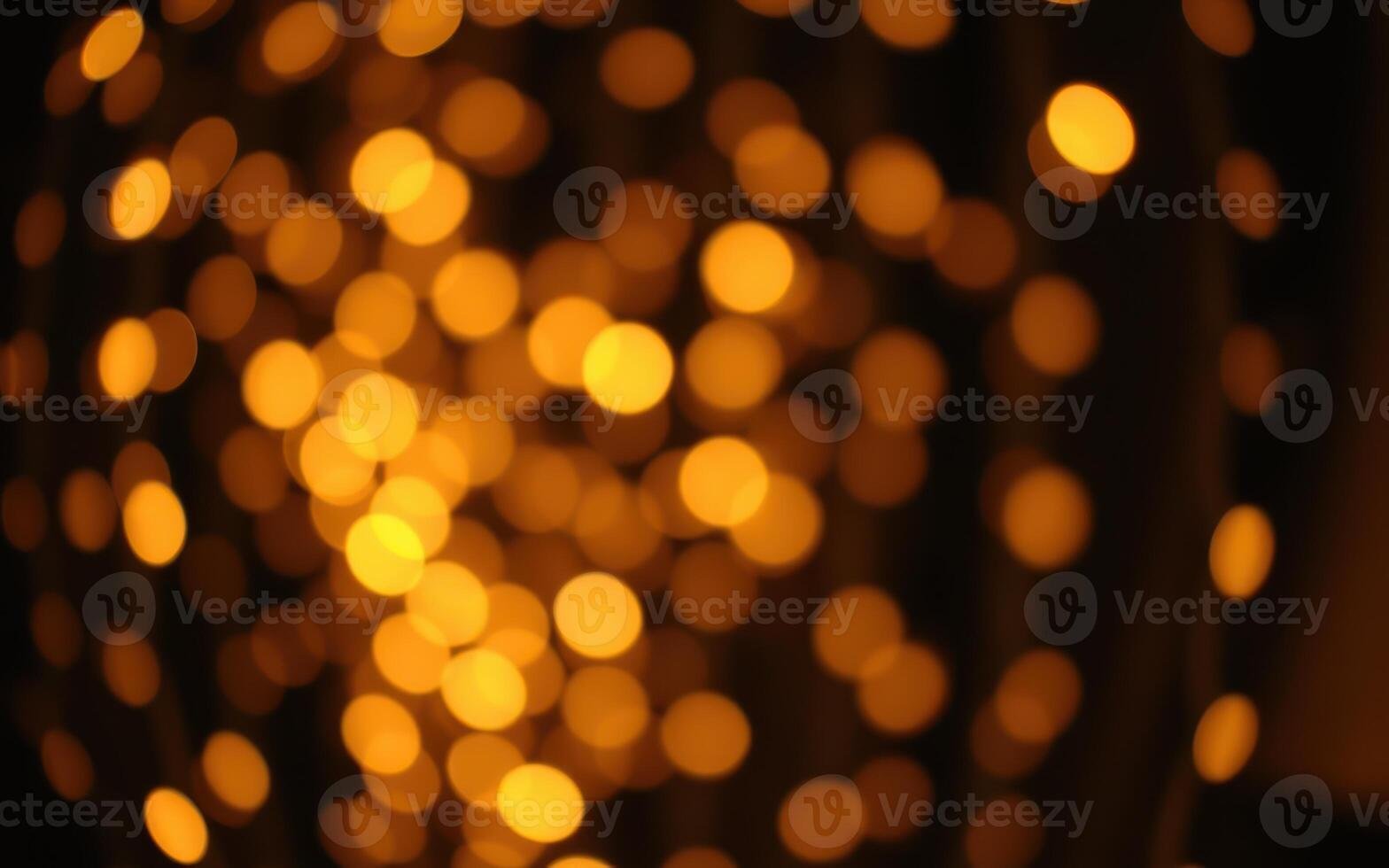 Warm glowing bokeh lights create a festive atmosphere during a nighttime celebration photo