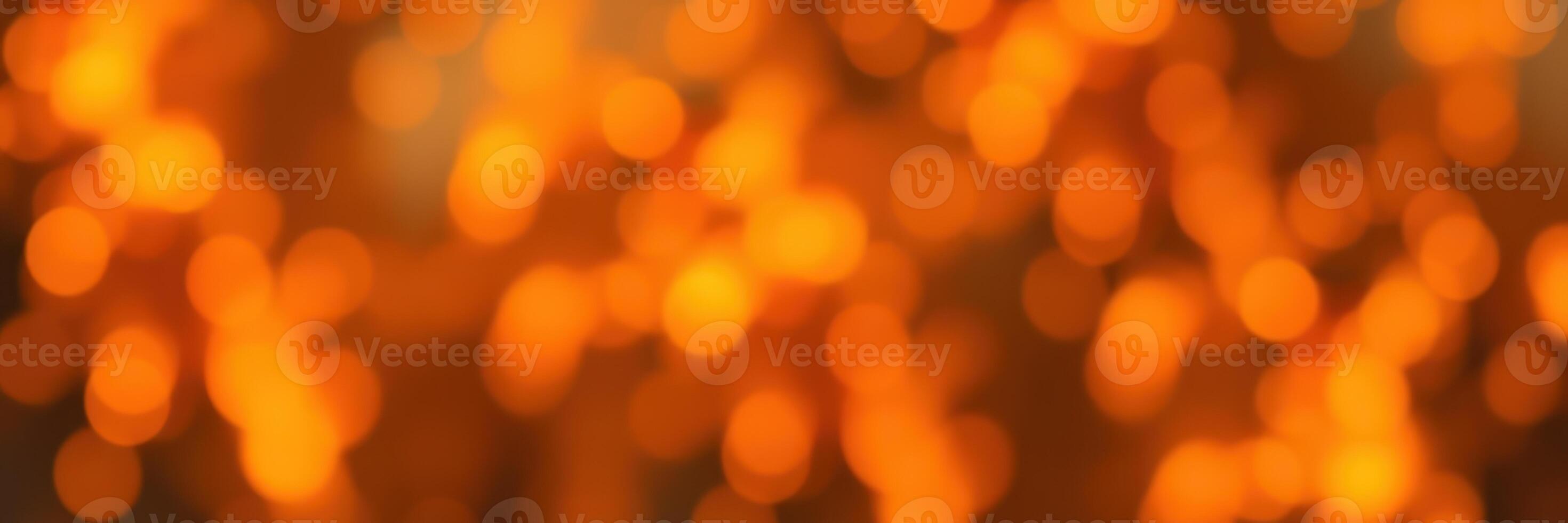 Vibrant orange bokeh lights create a warm atmosphere during an evening gathering photo