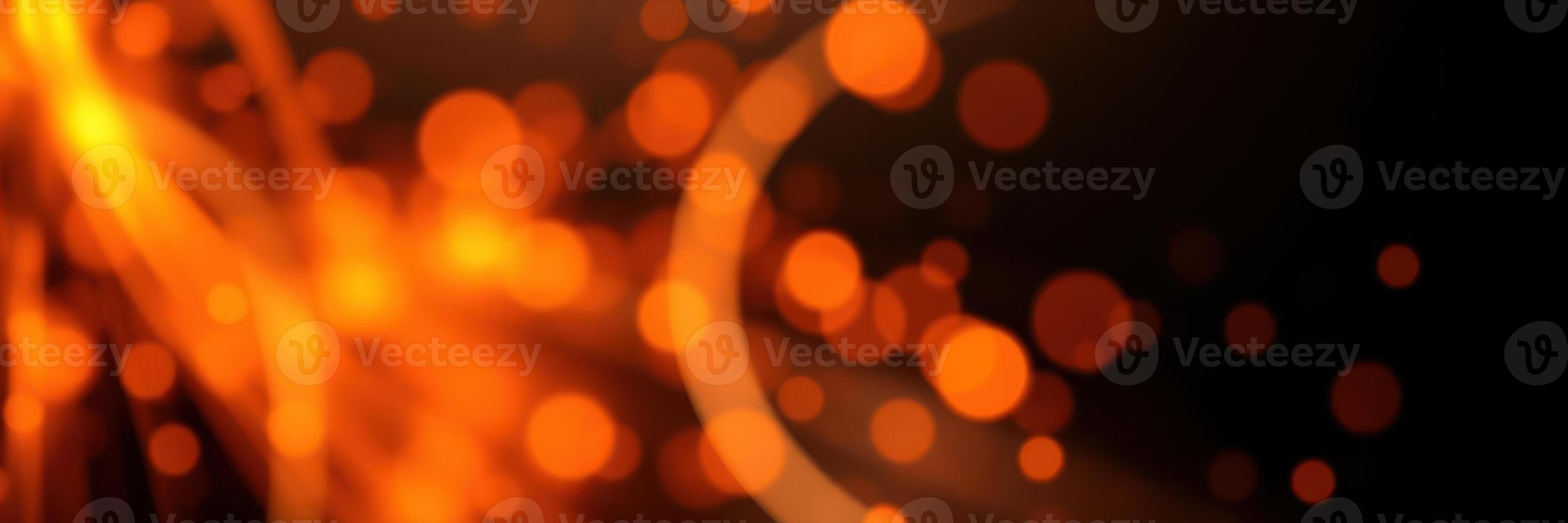 Bright orange sparks dance in the air against a dark background, creating a mesmerizing visual display during an evening bonfire photo