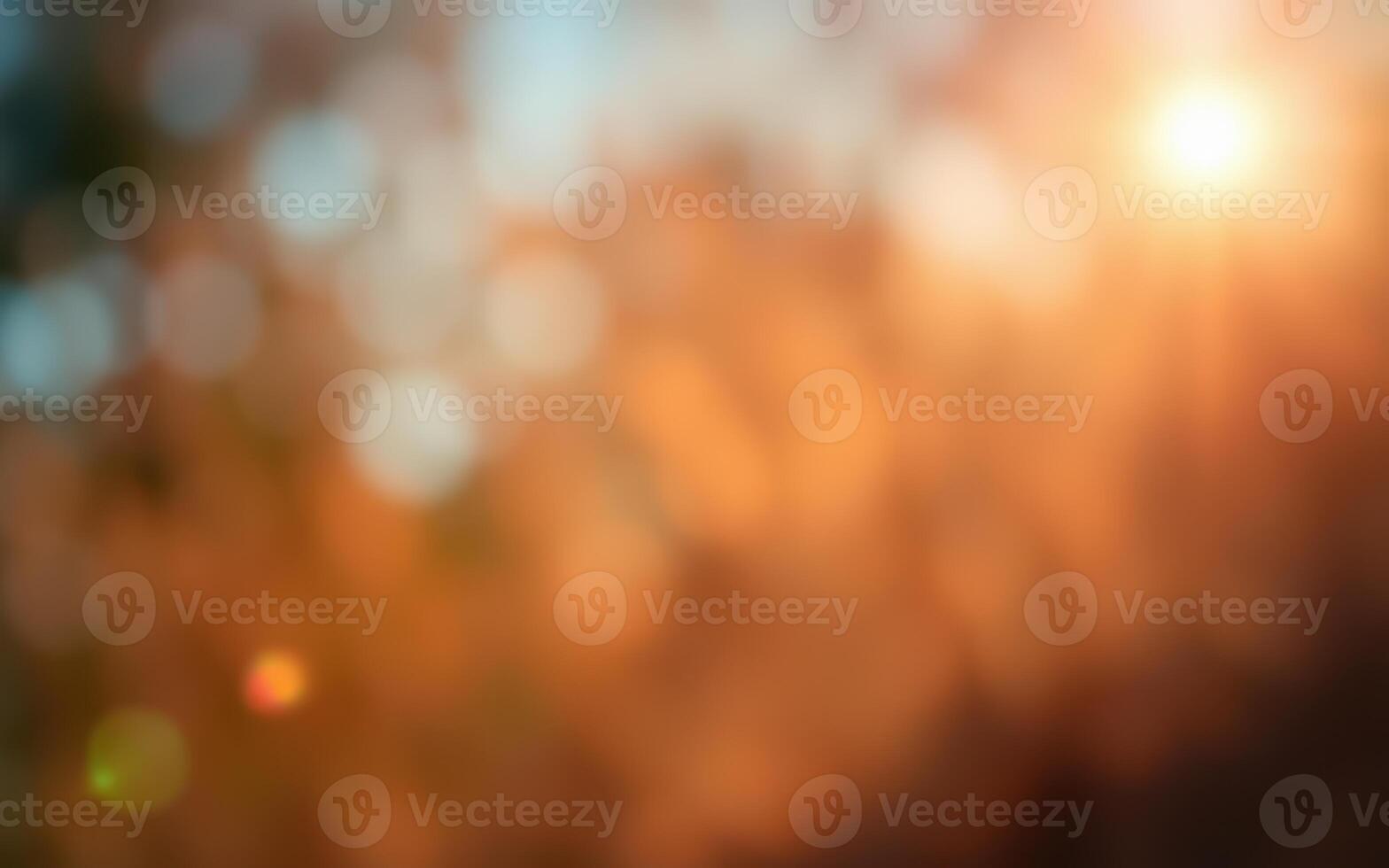 Natural sunlight filters through warm autumn foliage creating a soft, blurred background of orange and gold hues in a tranquil setting photo