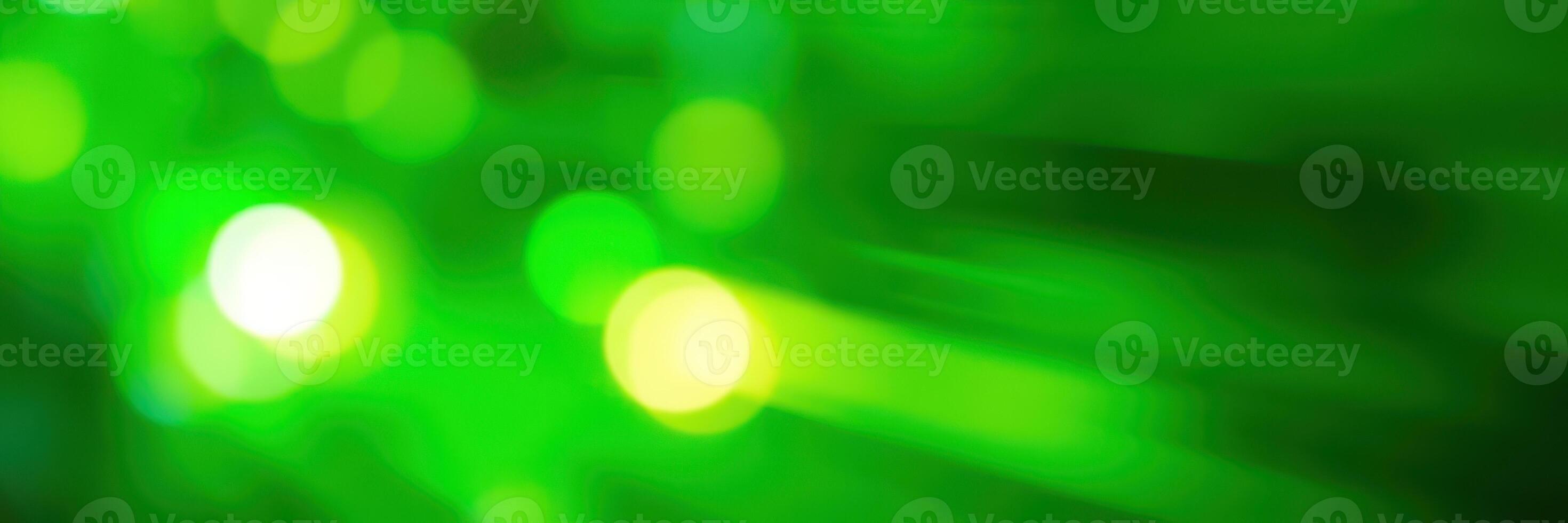 Vibrant green light reflections create an abstract visual experience in a dynamic environment during nighttime festivities photo