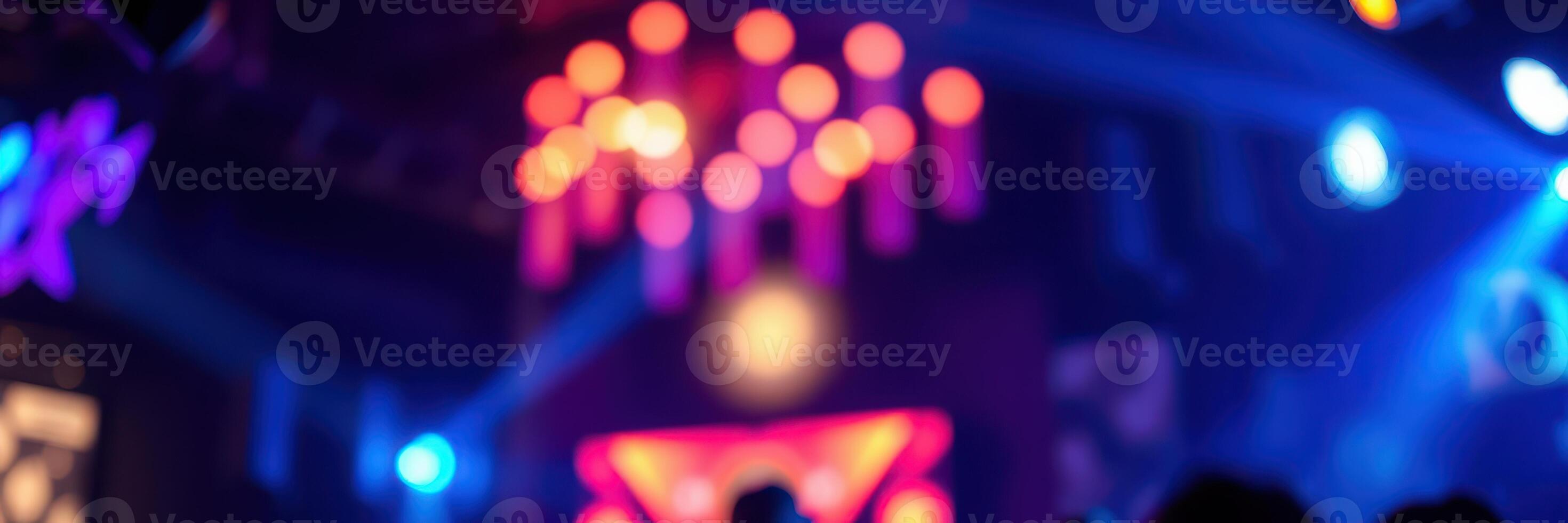 Vibrant nightlife atmosphere with colorful lights and energetic crowd dancing at a club during a lively event photo