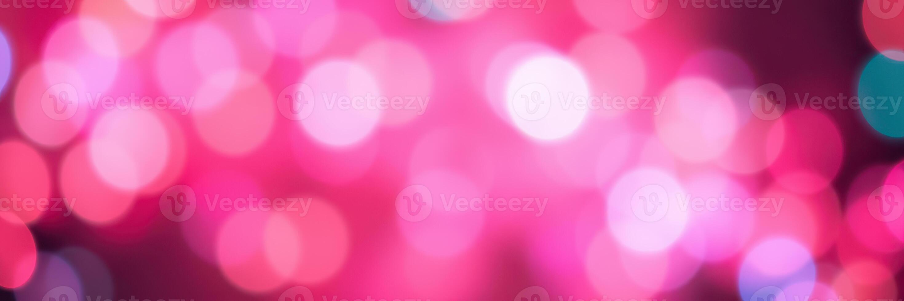 Bright pink bokeh lights create a festive and vibrant atmosphere at a nighttime celebration or event photo